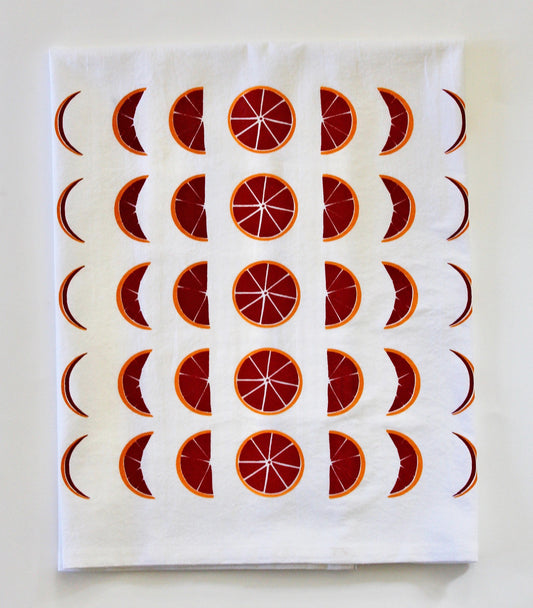 White tea towel with red and orange blood orange moon phases design