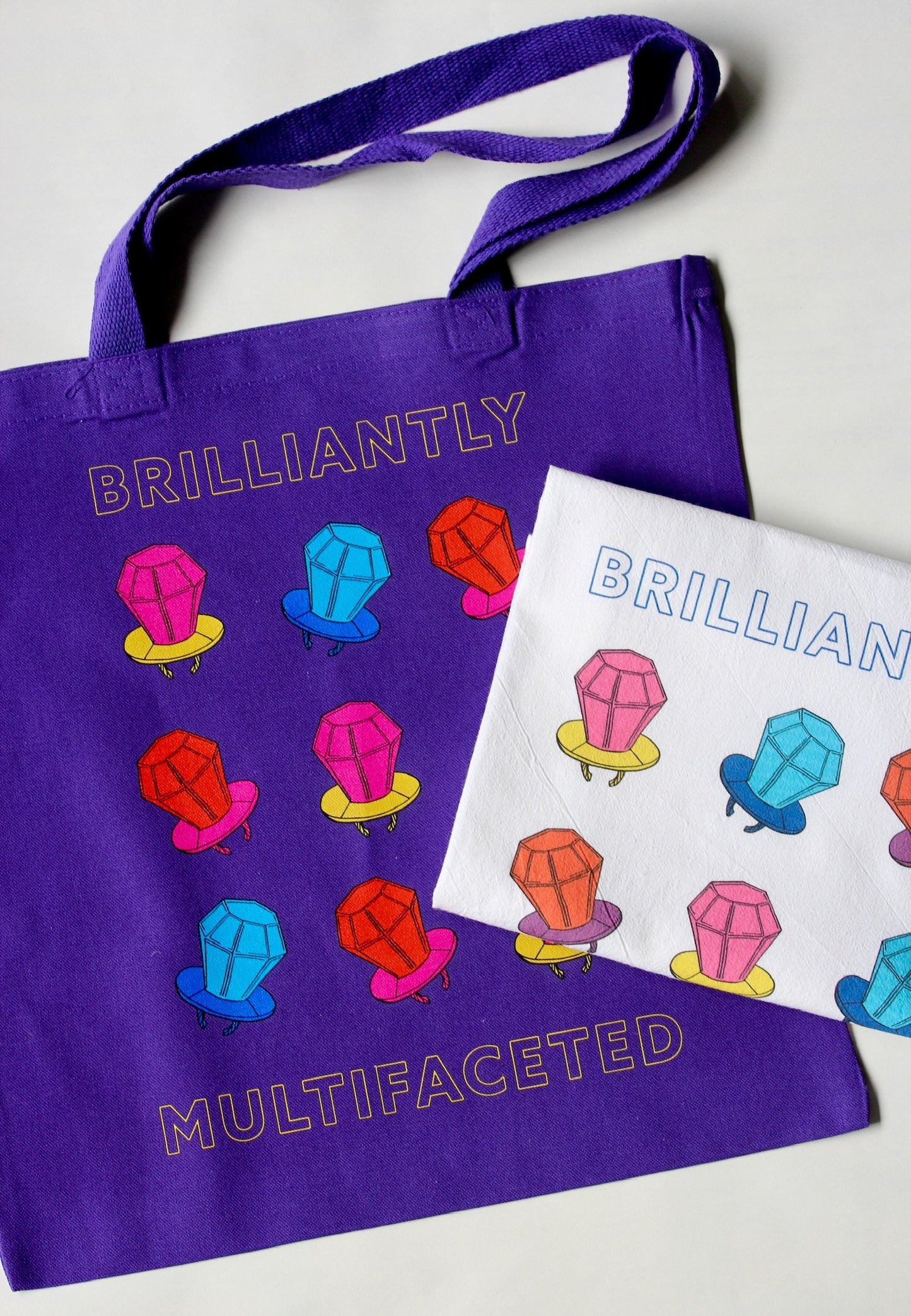Purple tote and white tea towel with bright candy design
