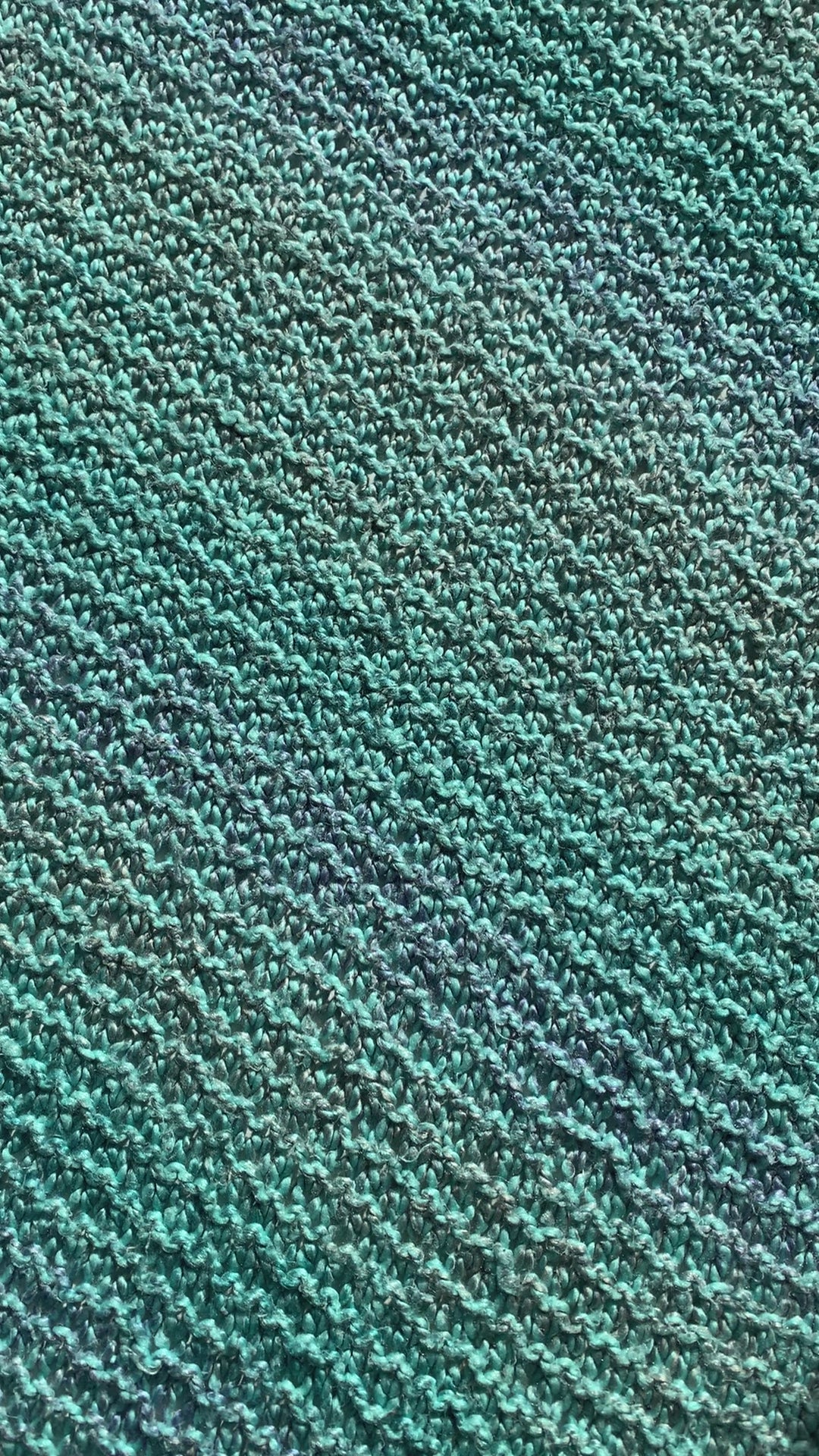 A woman places a purple baby onesie that reads "Flour Child" on a blanket