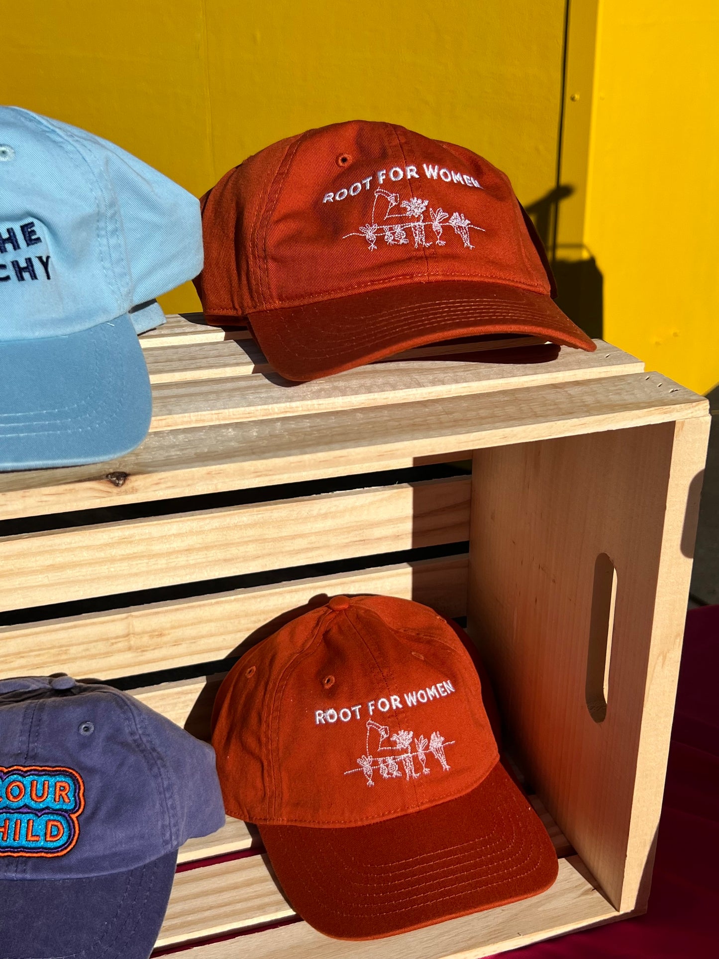 Baseball hats sit on and in a milk crate
