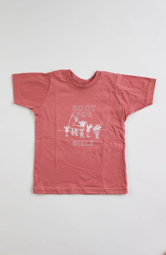 A mauve toddler tee with the words "Root for Girls" in white block letters and a garden illustration