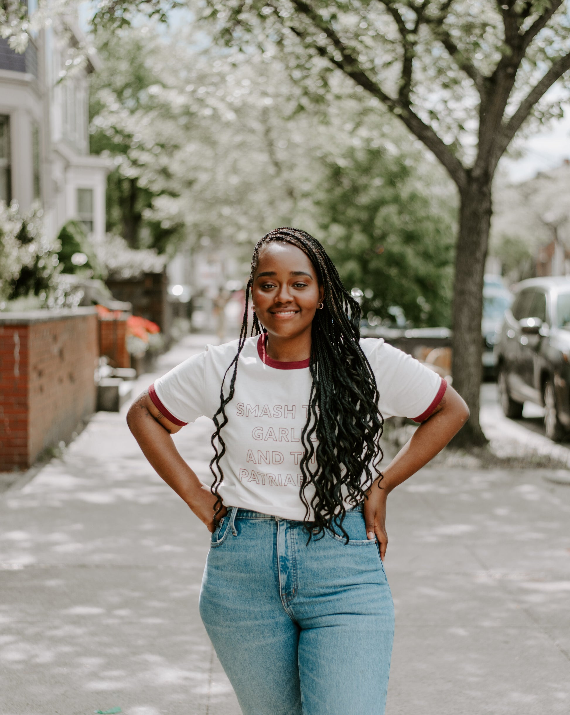 A woman wears a "Smash the Garlic and the Patriarchy" tee on a city sidewalk