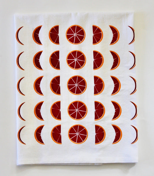 White tea towel with red and orange blood orange moon phases design