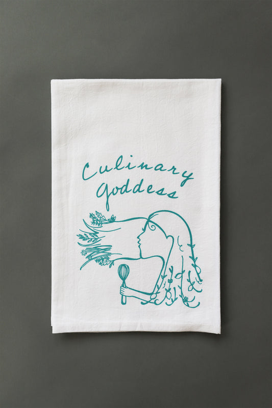 White teal towel with teal cursive writing that reads "Culinary Goddess" and illustration of a woman with a whisk