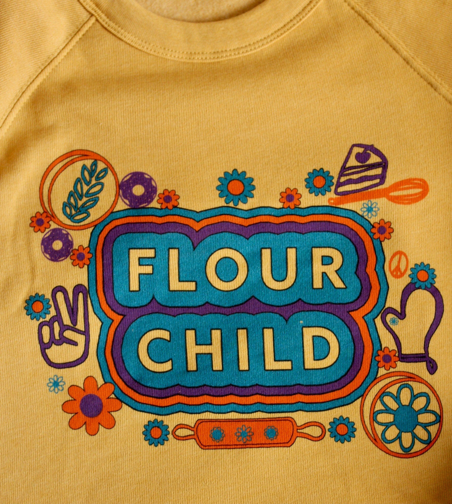 A close up of the Flour Child logo and kitchen and hippie designs