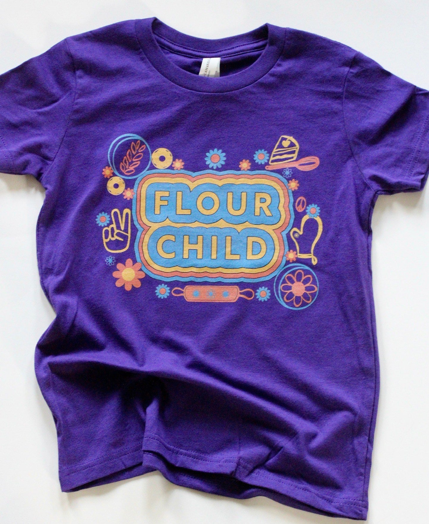 A purple youth tee with the words Flour Child and colorful illustrations