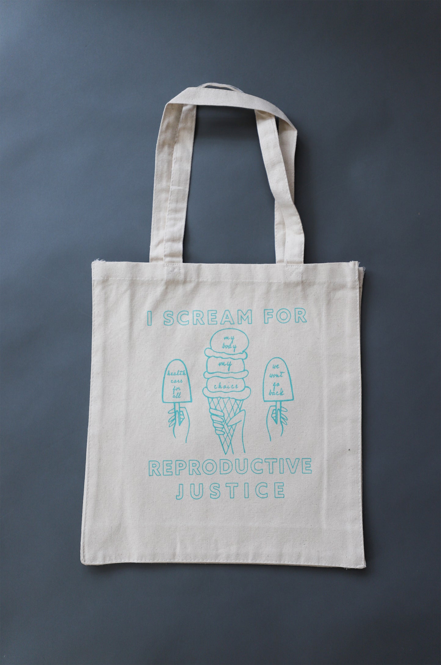 A canvas tote with the words I Scream for Reproductive Justice and ice cream designs in mint green