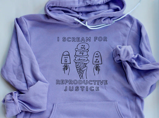 A lavender hoodie with the words I Scream for Reproductive Justice in black block letters with ice cream illustrations 