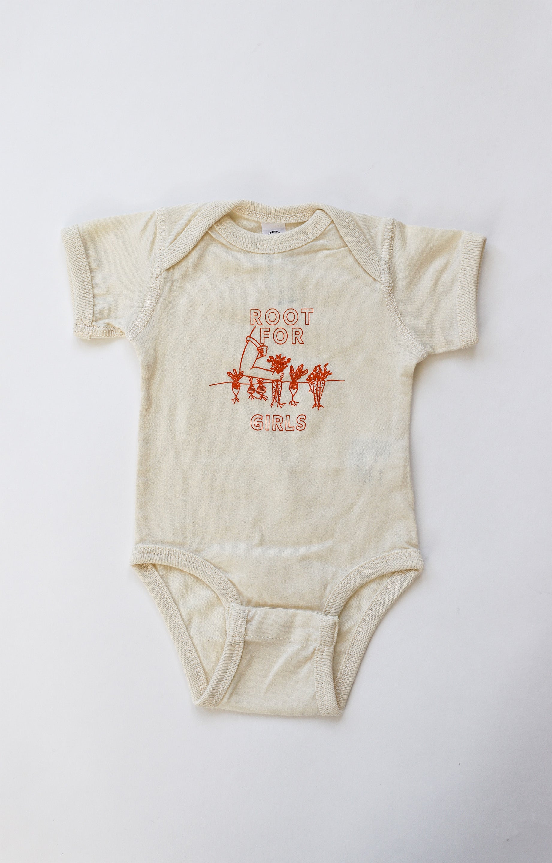 Natural color baby onesie with "Root for Girls" in orange block letters with a garden illustration 