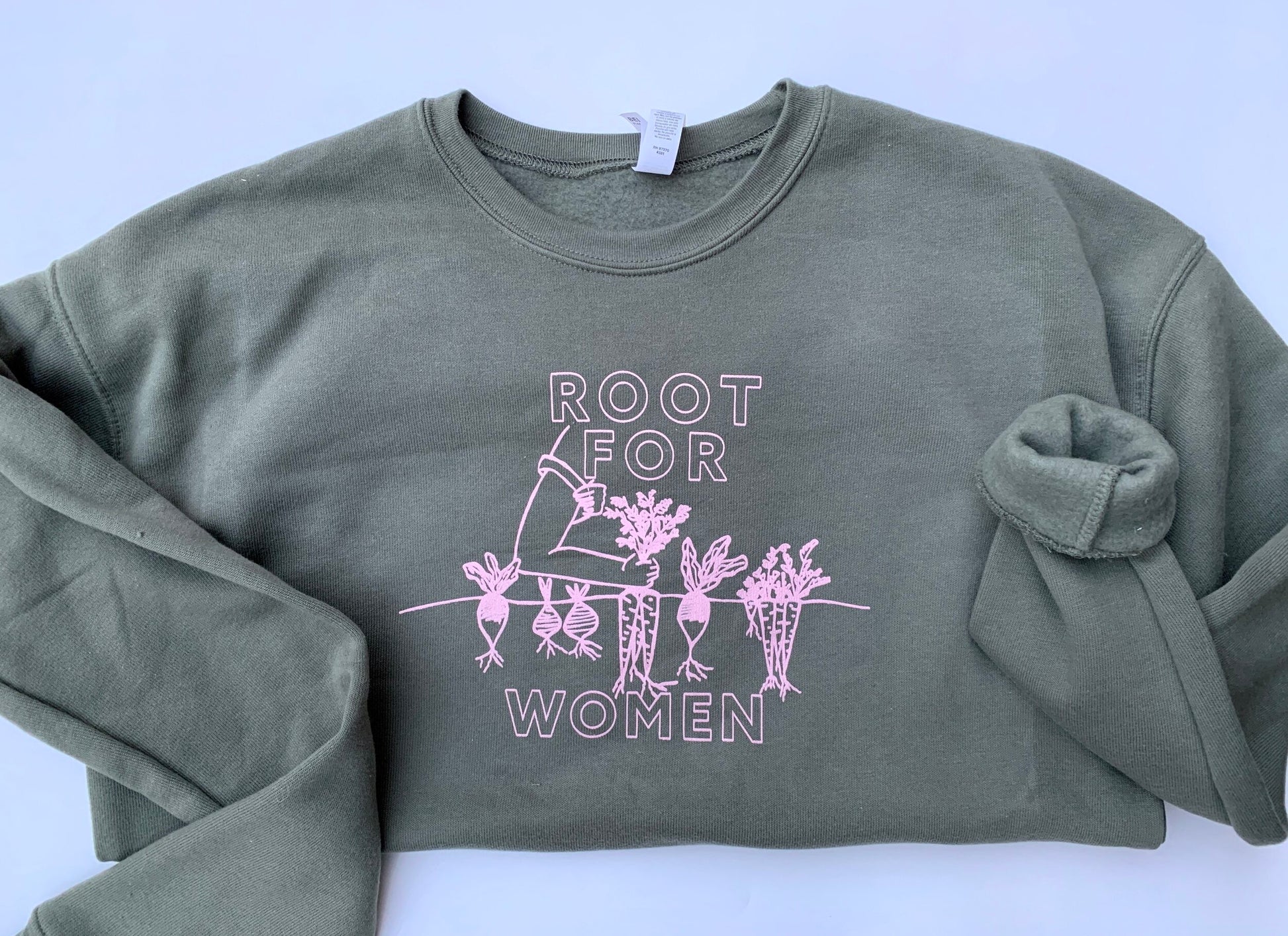 A green crewneck reads "Root for Women" in white block letters