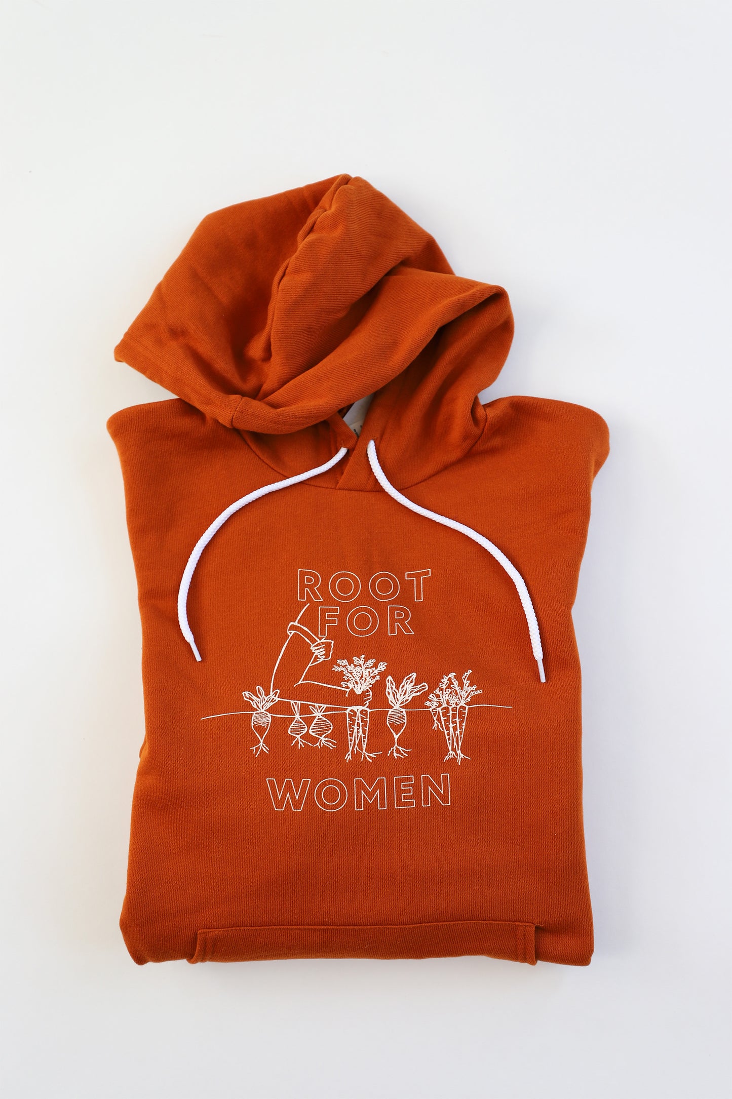 A folded orange hoodie reads "Root for Women" in white block letters