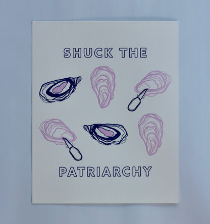 An art print reads "Shuck the Patriarchy" in block letters with oyster illustrations 