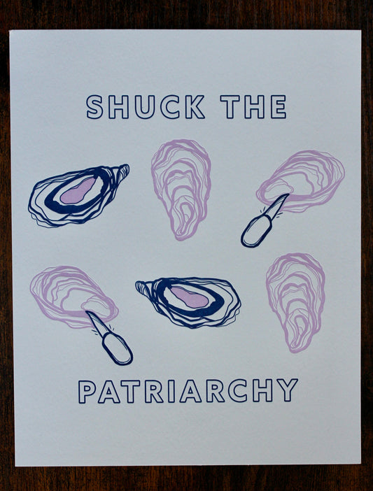 An art print with "Shuck the Patriarchy" in blue block letters and pink and blue oyster designs