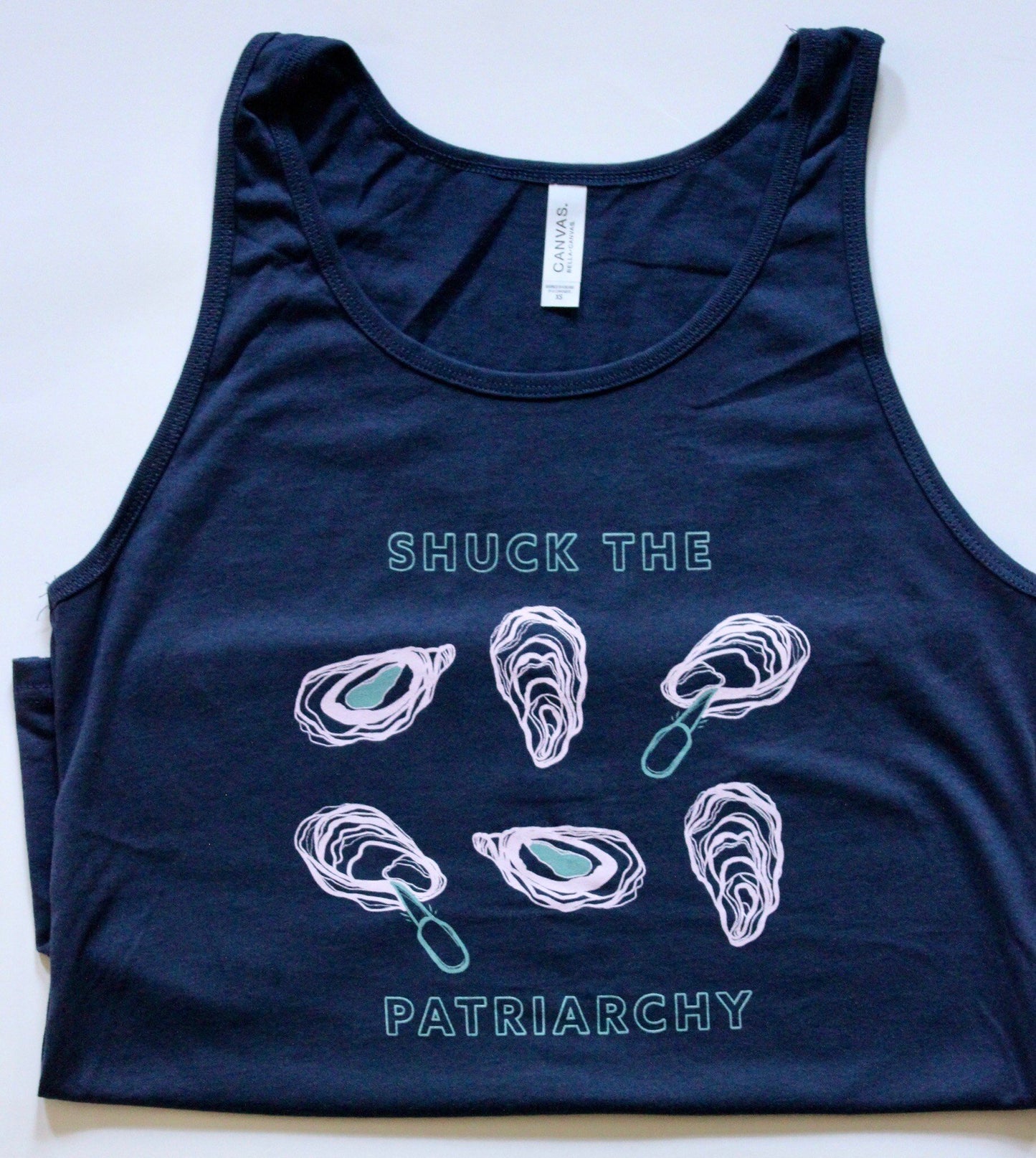 A navy tank that reads "Shuck the Patriarchy" in blue block letters with oyster illustrations 
