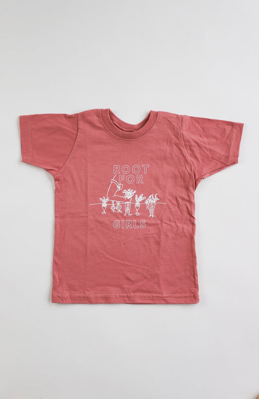 A mauve toddler tee with the words "Root for Girls" in white block letters and a garden illustration 
